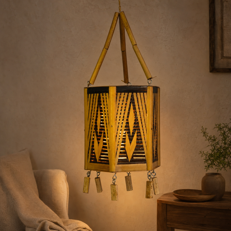 Handcrafted Bastar bamboo hanging lamp glowing in a warm living-room reading corner