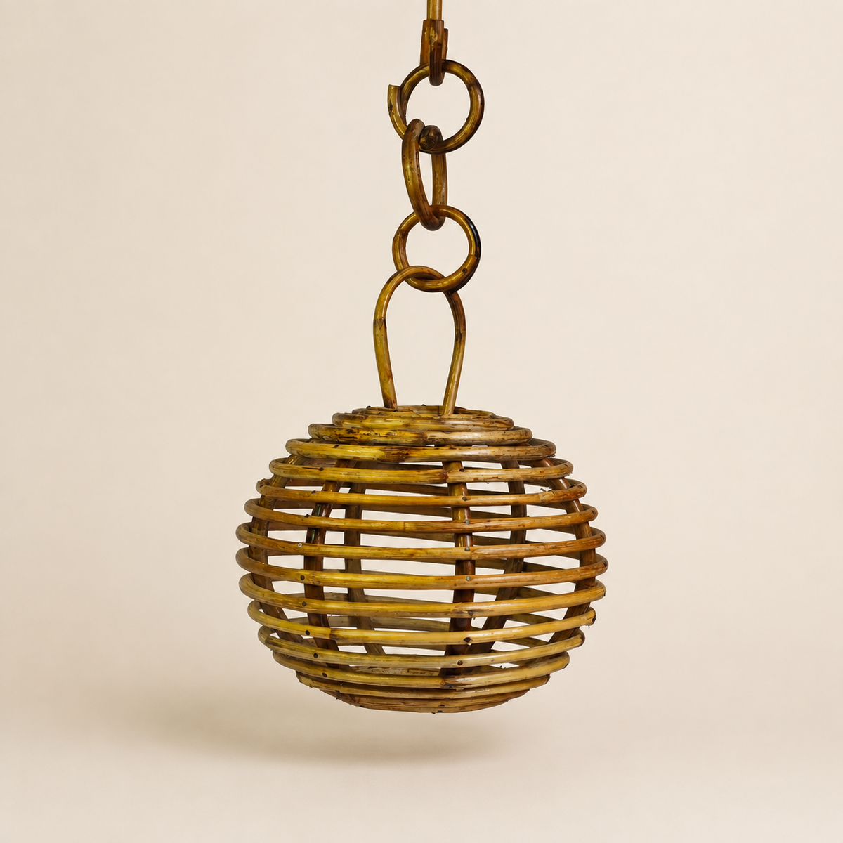 Round handcrafted Bastar bamboo hanging lamp on a clean warm ivory studio background