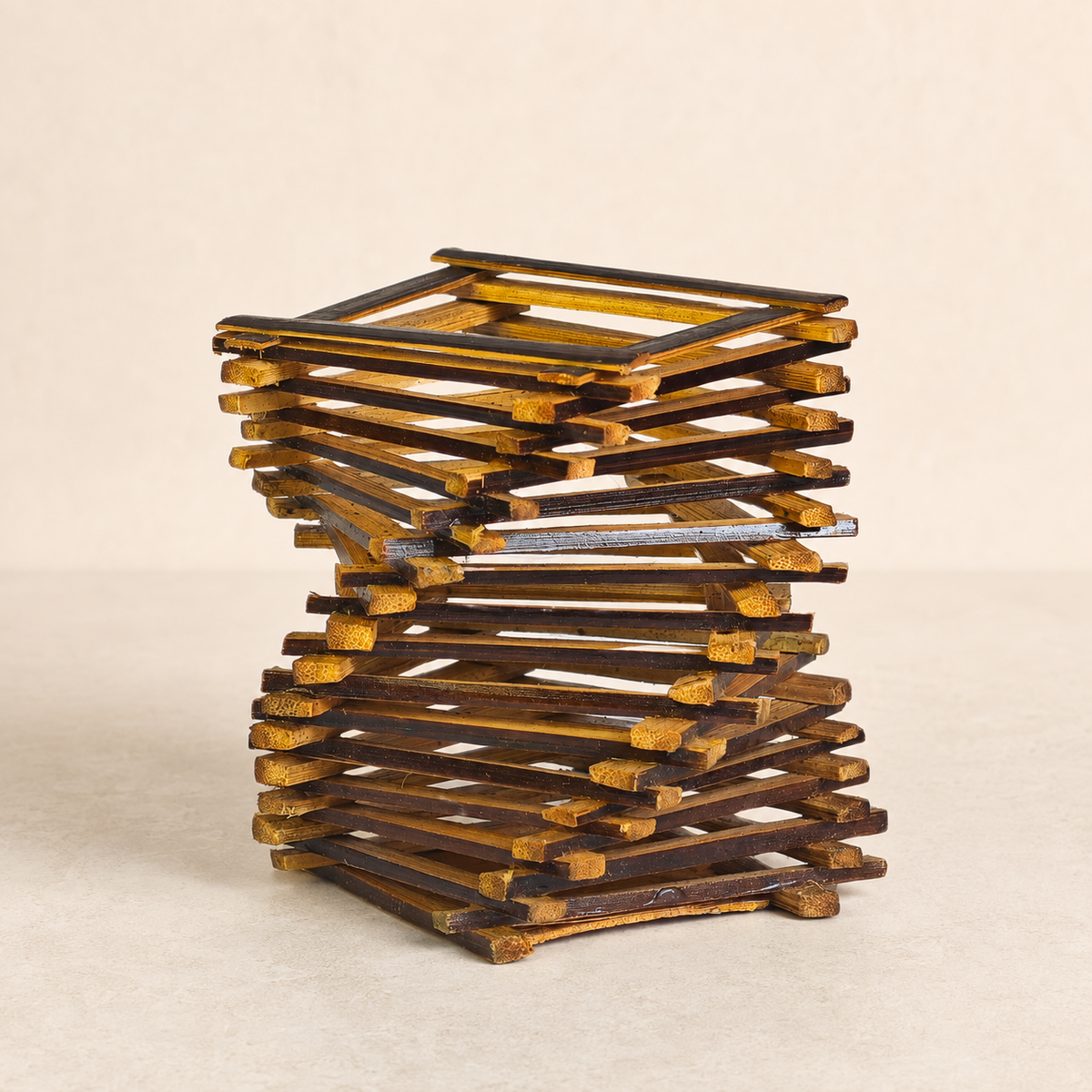 Handcrafted dark and golden bamboo pen stand on a clean ivory studio background