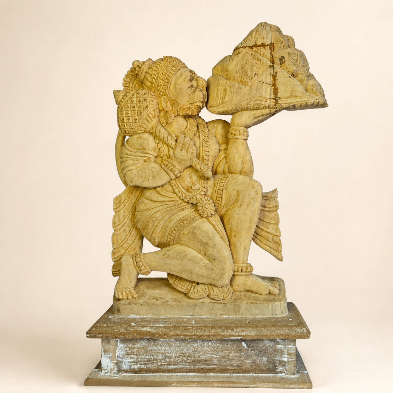 Hand-carved Bastar wooden Bajrangi statue on a clean warm ivory studio background