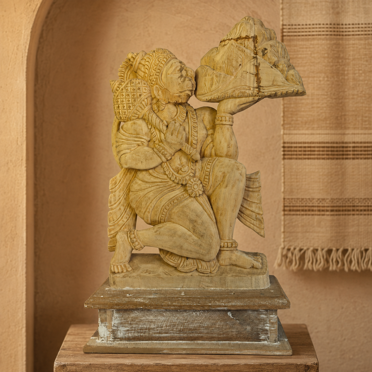 Hand-carved wooden Bajrangi statue in a terracotta Bastar craft editorial setting