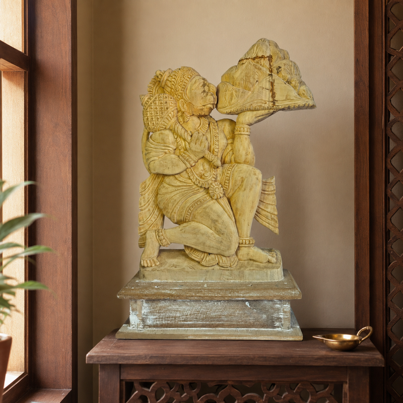 Bastar wooden Bajrangi statue displayed in a warm home prayer alcove