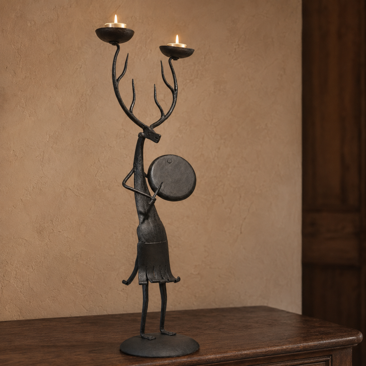 Bastar wrought iron antlered musician candle holder with two lit tealights