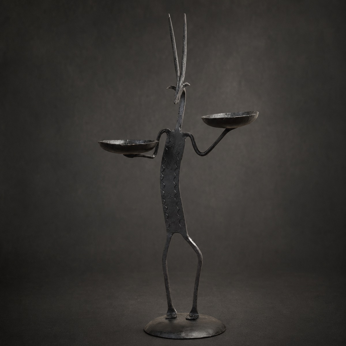 Craftsmanship view of the hand-forged Bastar deer candle holder