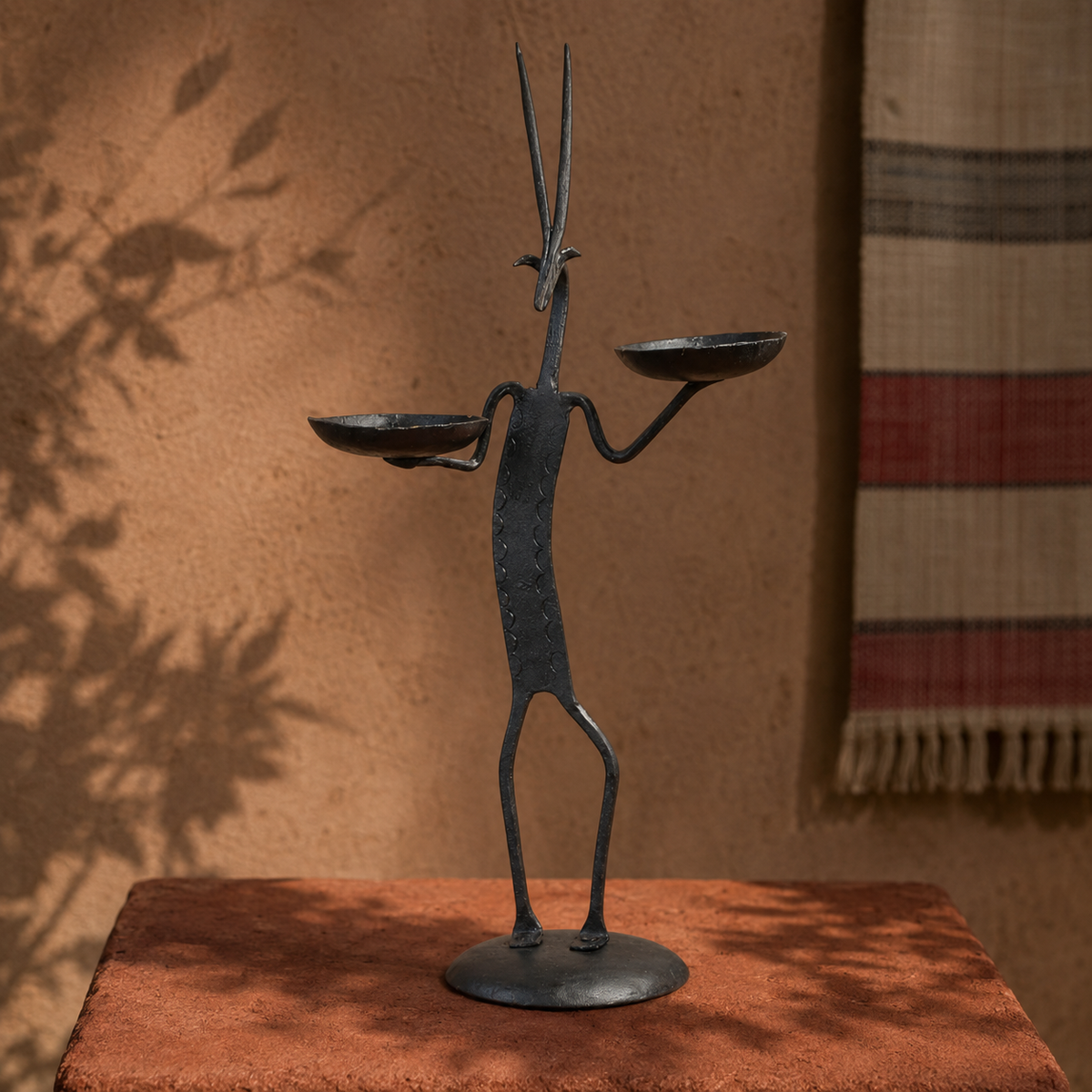 Bastar wrought iron deer candle holder in an earthy craft editorial setting