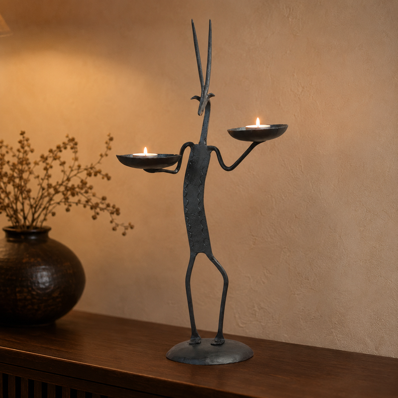 Bastar wrought iron deer candle holder with two lit tealights on a living room console