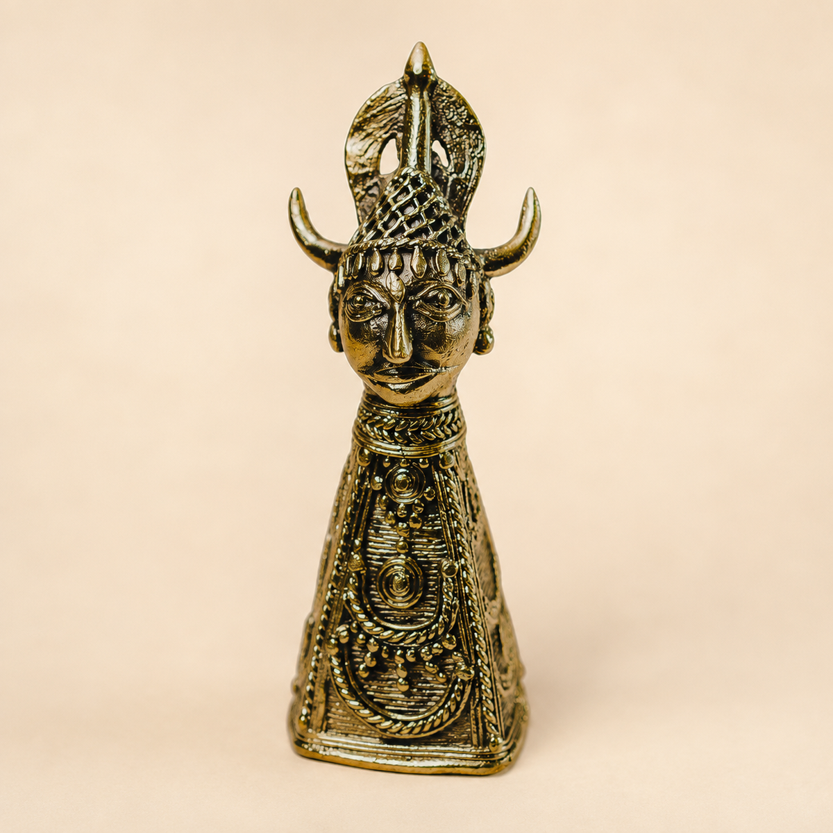 Dhokra Bison Horn Maria brass paperweight on a warm ivory studio background