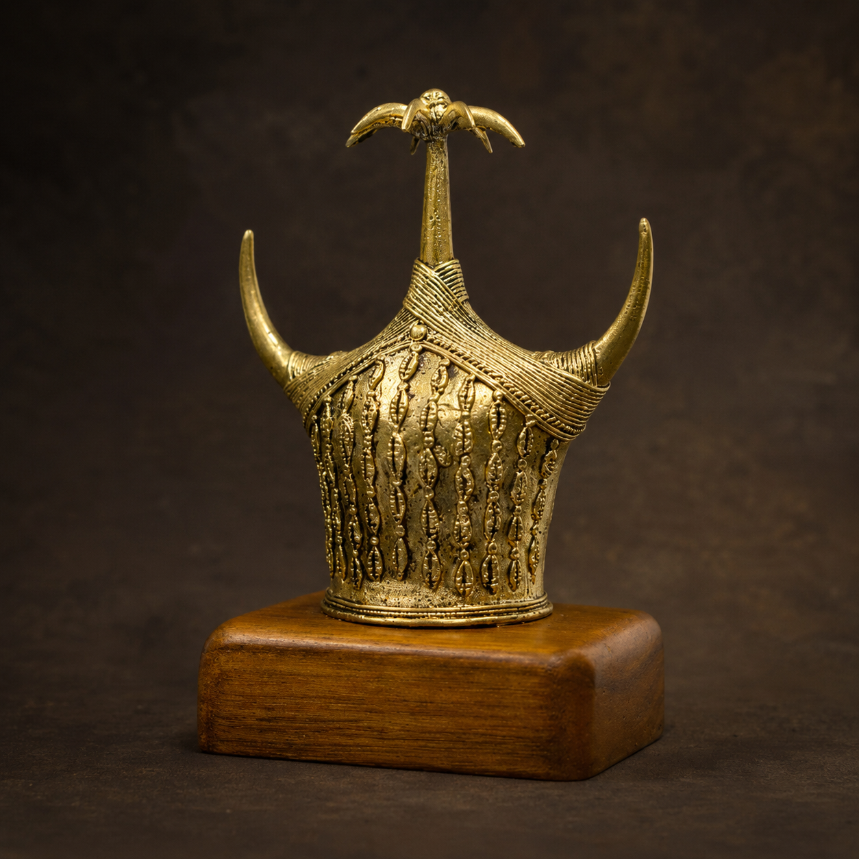Detailed Dhokra Bison Horn memento showing relief motifs, ribbed bands and brass patina