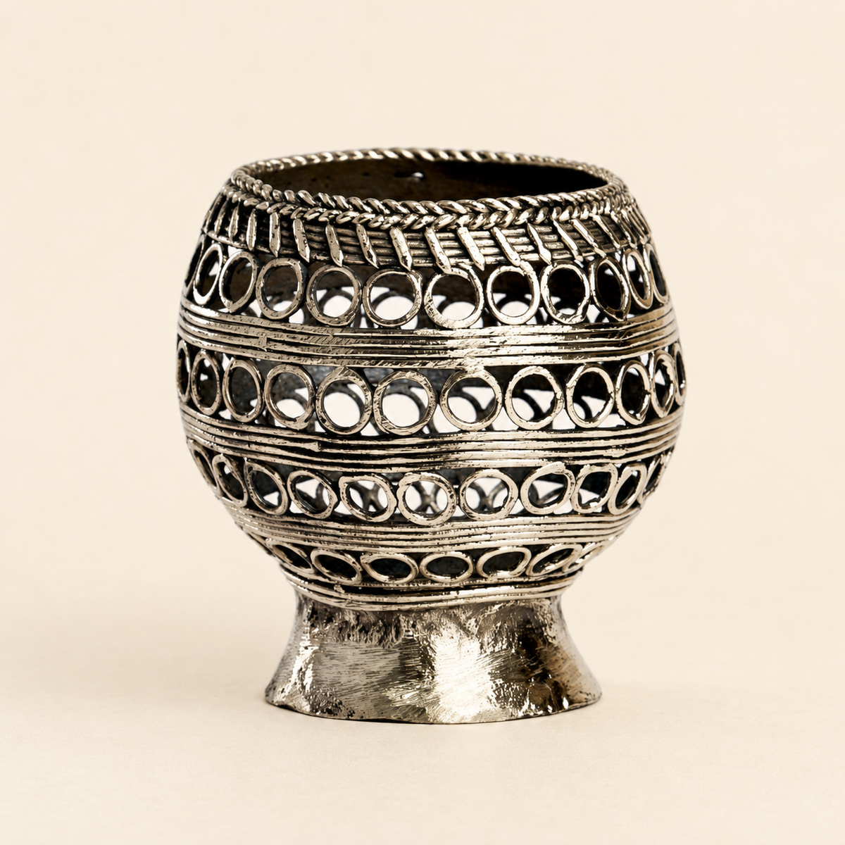 Dhokra candle holder and pen stand on a warm ivory studio background