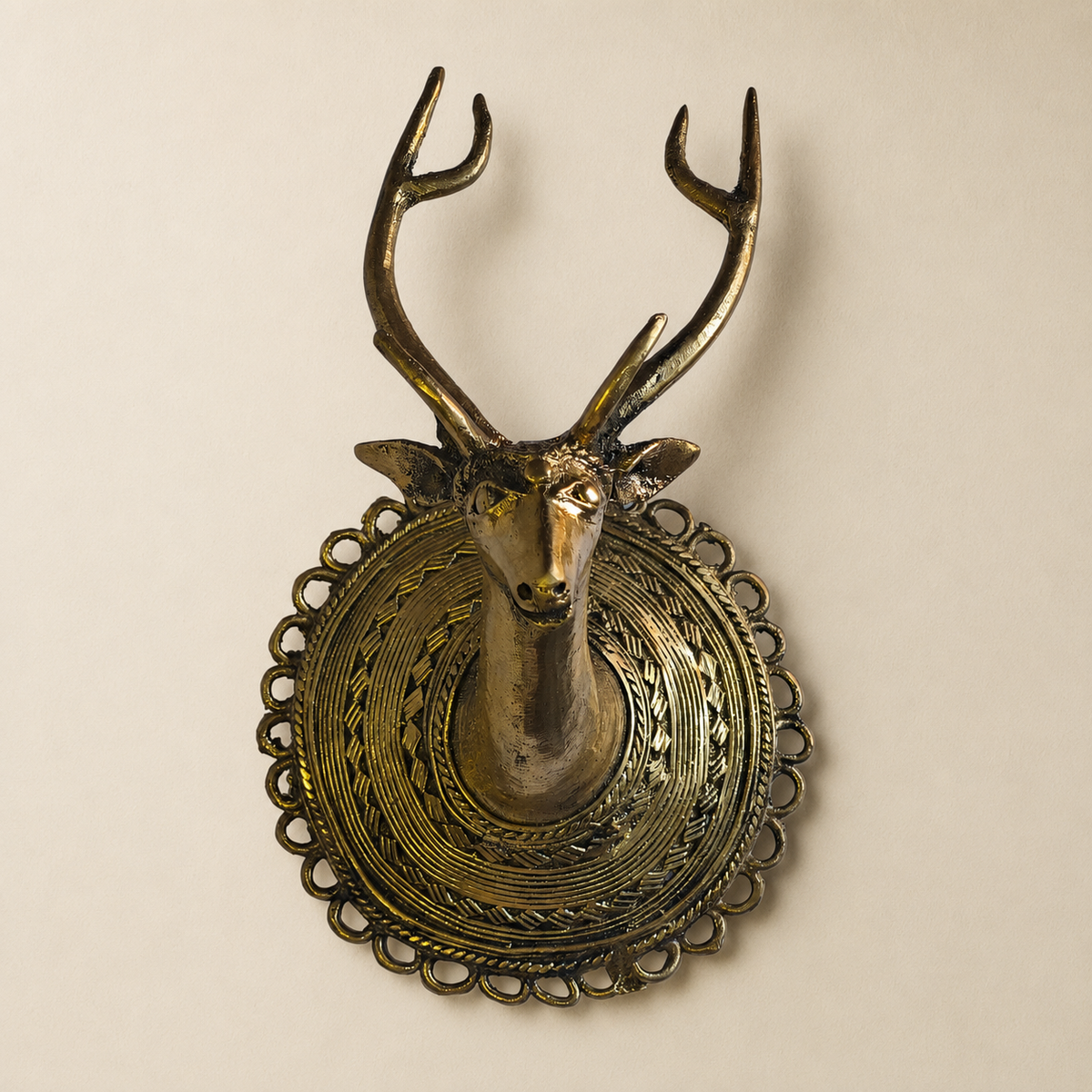 Dhokra Deer Head Design 1 brass wall showpiece on a warm ivory studio wall