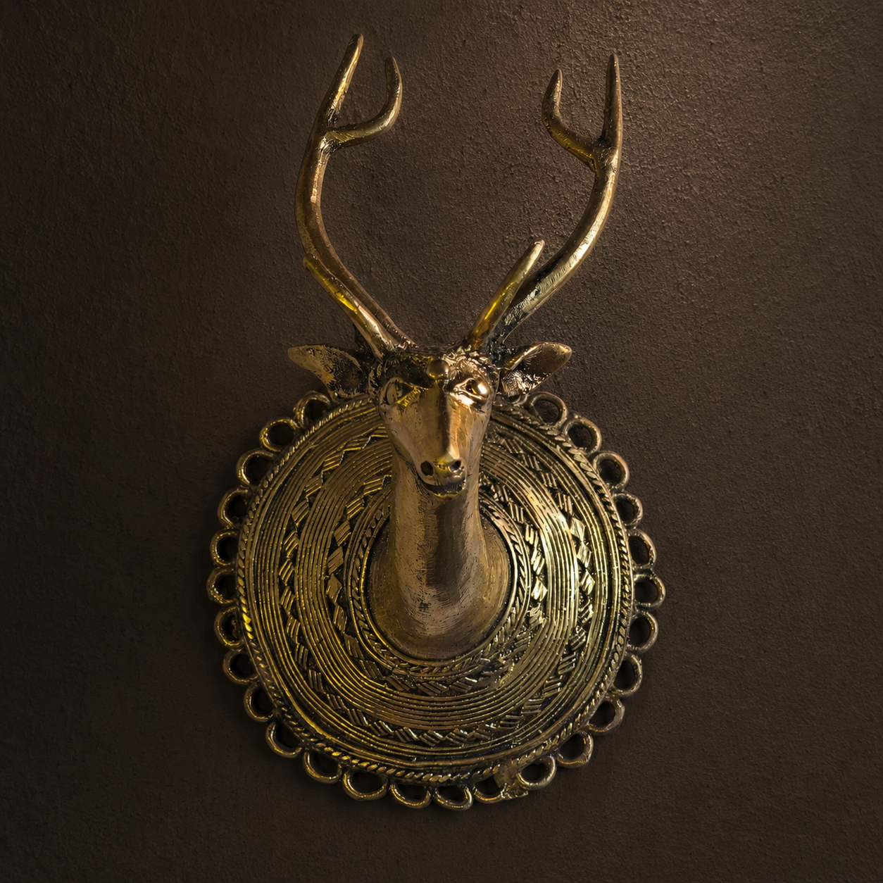 Detailed view of Dhokra Deer Head Design 1 showing antlers, facial casting, coiled medallion and loop border