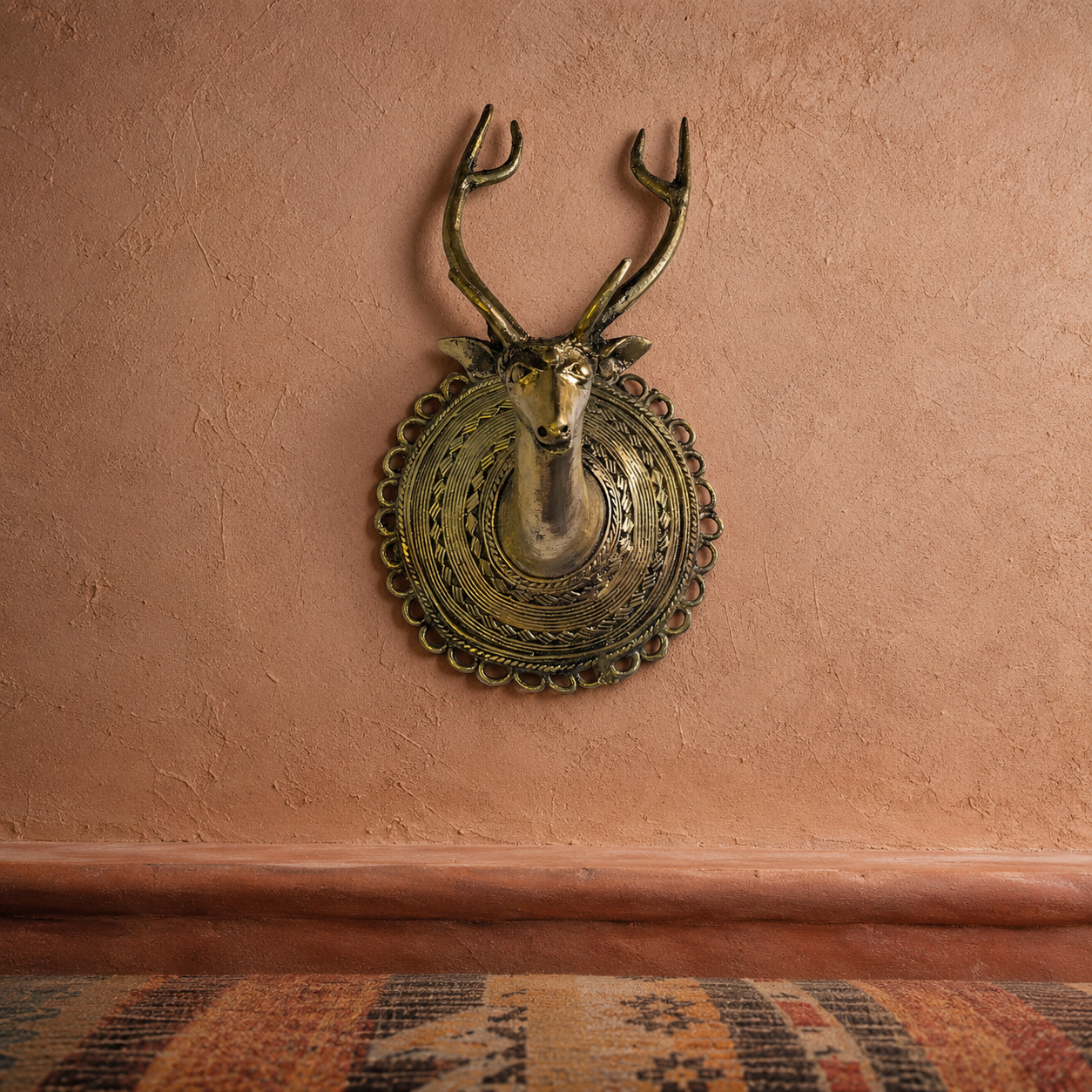 Dhokra Deer Head Design 1 mounted on a clay wall in a Bastar-inspired editorial setting