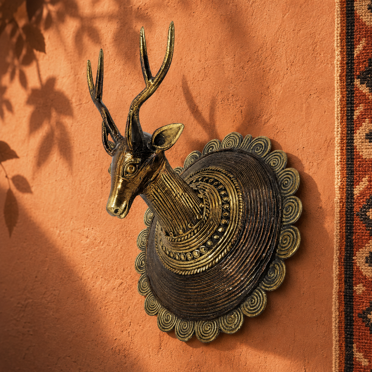 Dhokra Deer Head Design 2 on an earthy clay wall in a Bastar-inspired editorial setting