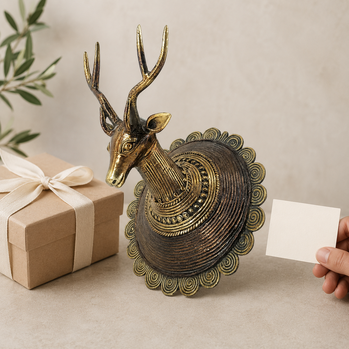 Dhokra Deer Head Design 2 brass showpiece beside a ribboned gift box and note card