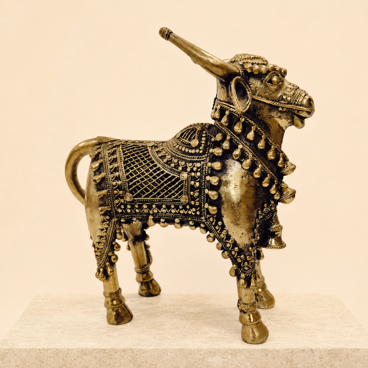 Ornate Dhokra Designer Nandi displayed on a warm sandstone plinth