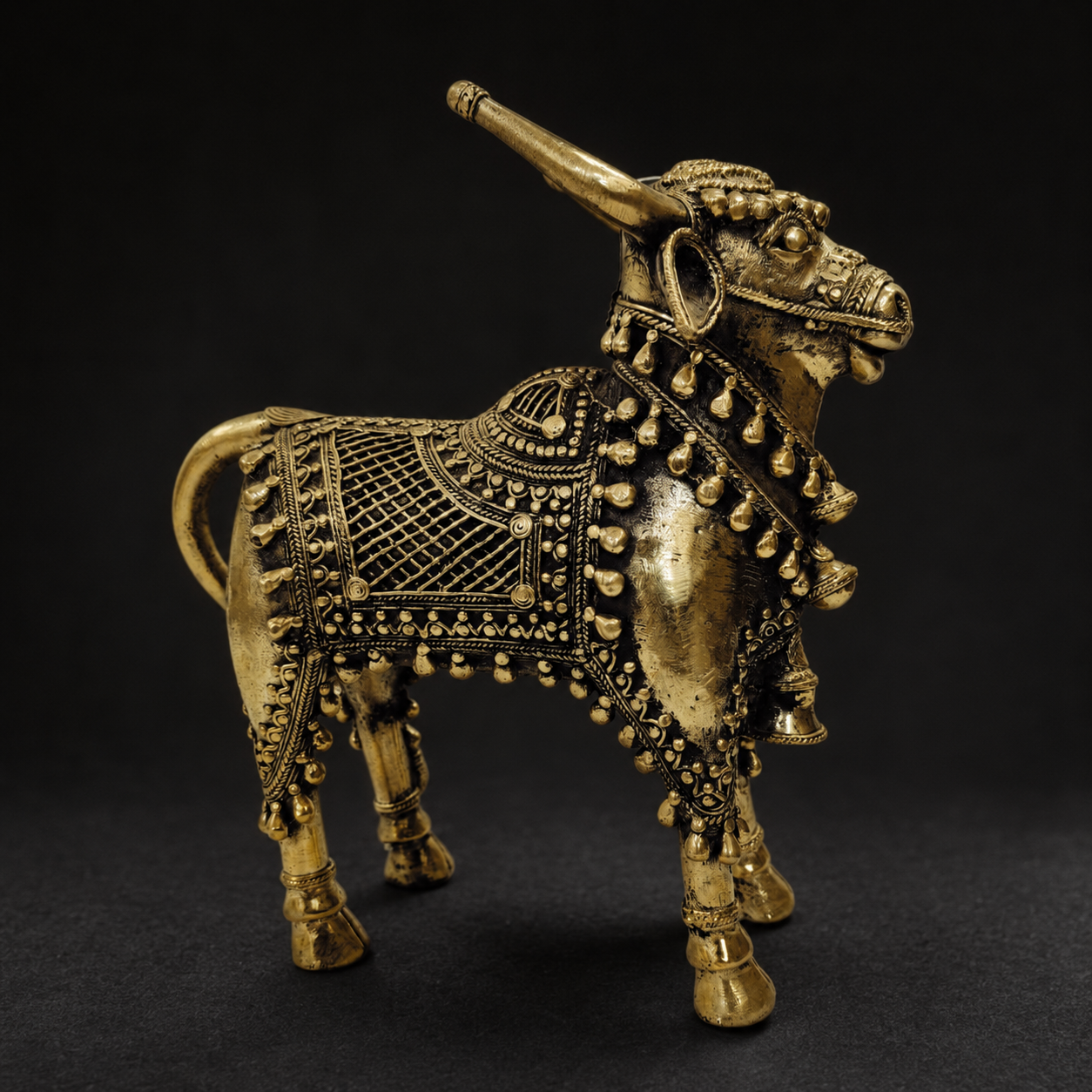 Detailed view of the lattice, bells and lost-wax brass work on the Dhokra Nandi