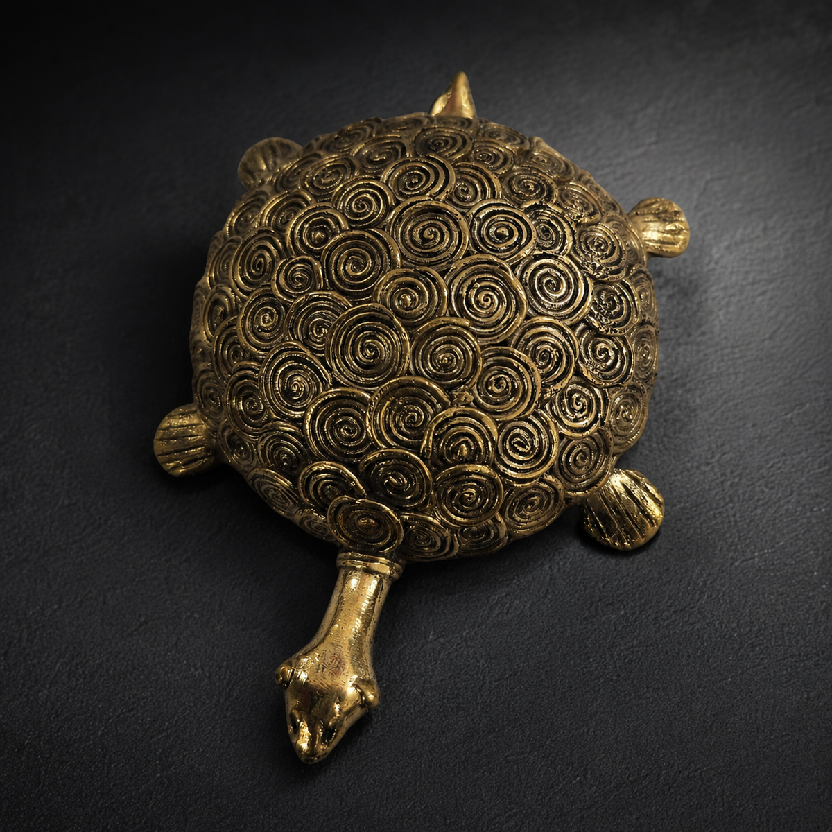 Detailed view of the spiral lost-wax brass work on the Dhokra turtle