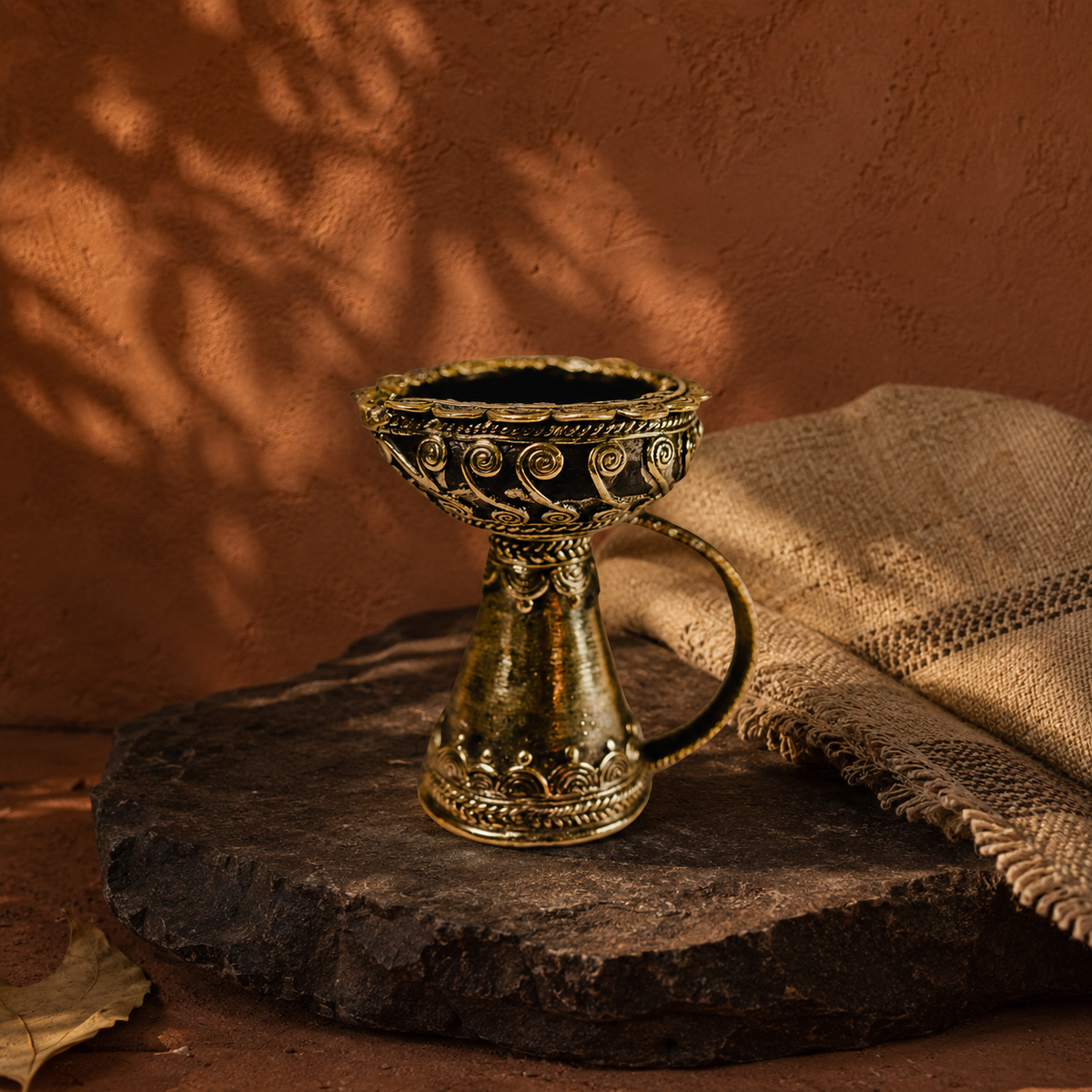 Dhokra brass diya in an earthy Bastar-inspired editorial setting