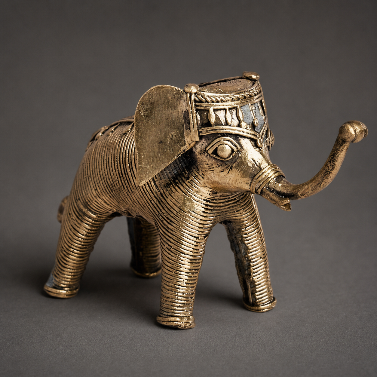Close craftsmanship view of the ribbed brass and geometric detailing on Dhokra Elephant Design 7