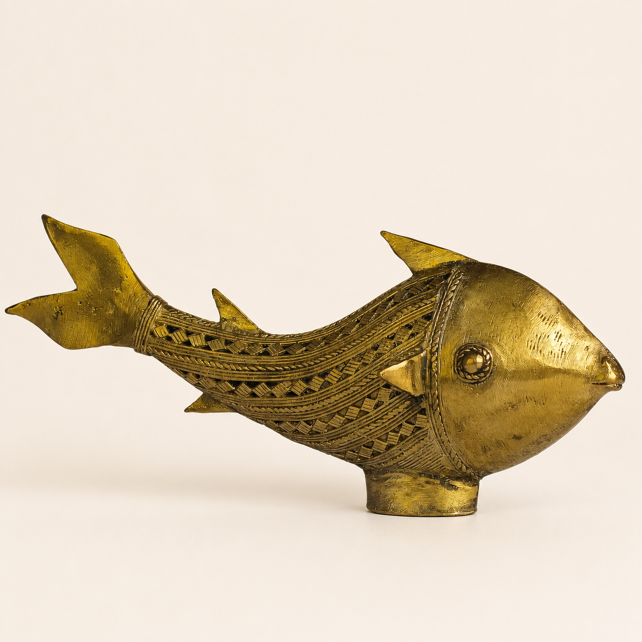 Dhokra Fish brass figurine in right-facing profile on a warm ivory studio background