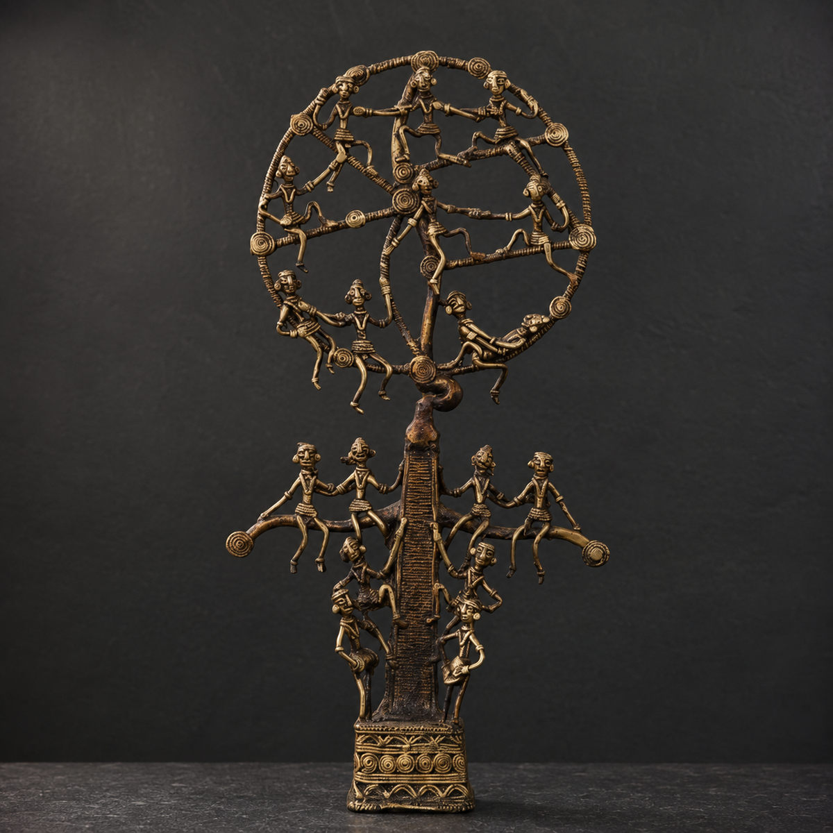 Detailed view of the dancers, coiled metalwork and patterned base of a Dhokra Karma Tree