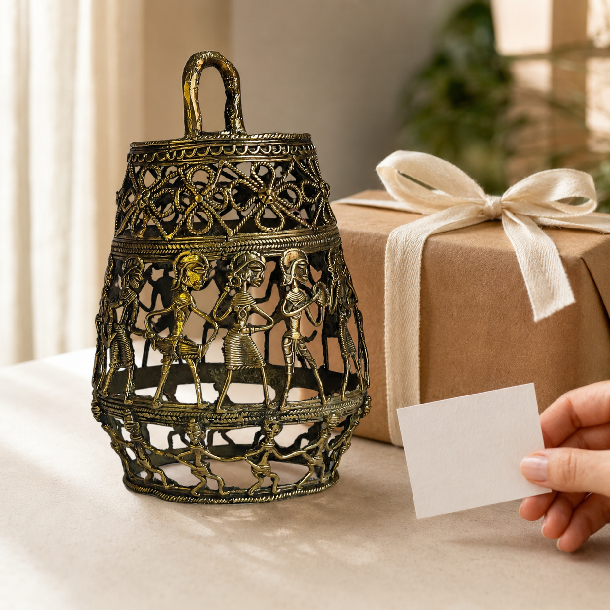 Dhokra Lamp Design 3 openwork brass tribal lamp beside a ribboned gift box and note card