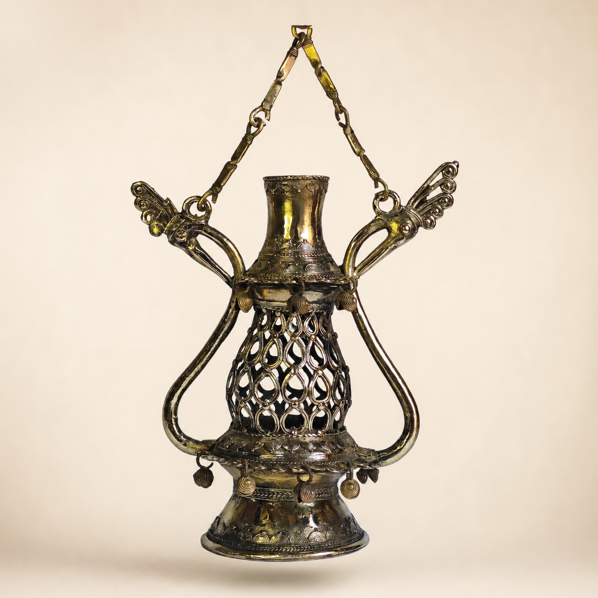 Dhokra Lantern Design 1 suspended against a warm ivory studio background
