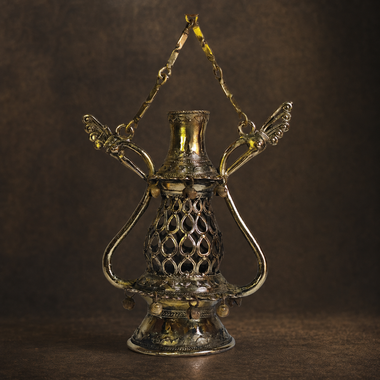Detailed view of Dhokra Lantern Design 1 showing bird arms, teardrop lattice, relief bands and hanging charms
