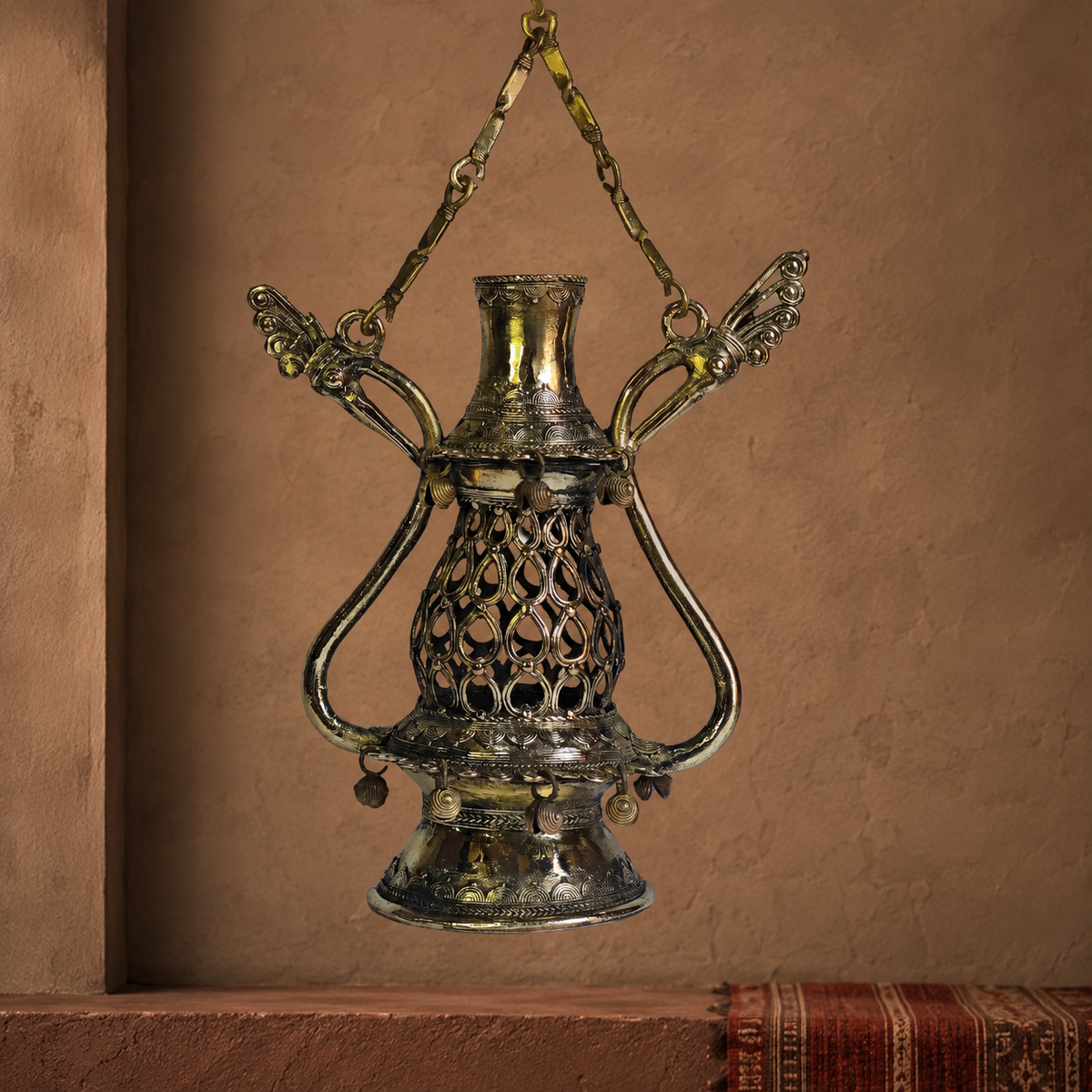 Dhokra Lantern Design 1 displayed against a clay wall in a Bastar-inspired setting