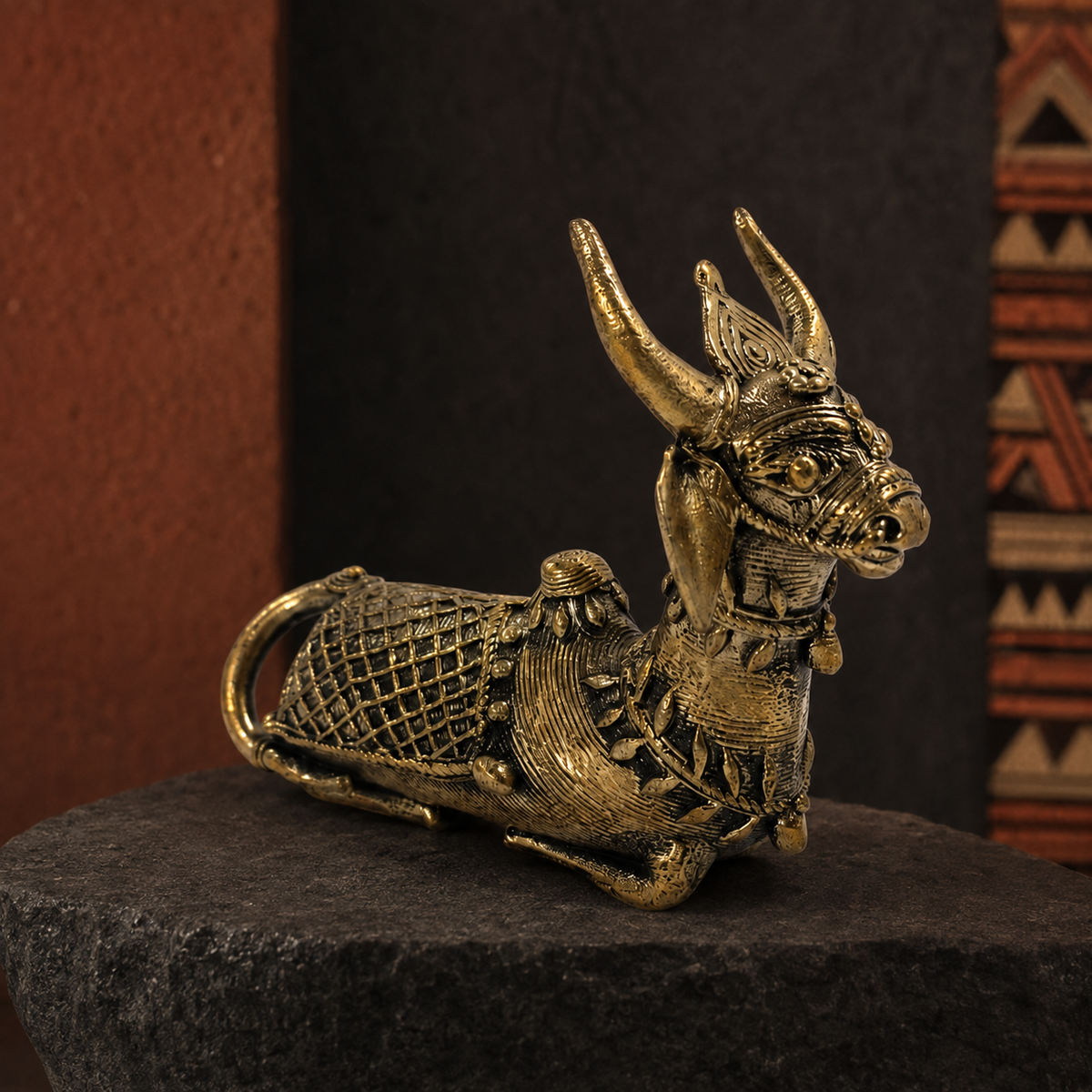 Dhokra Mini Nandi displayed on dark stone in a Bastar-inspired editorial setting