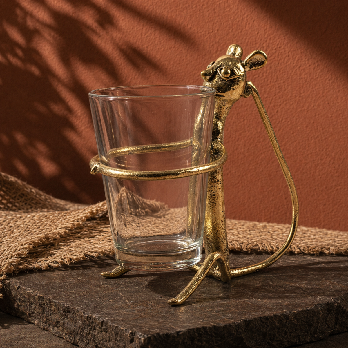 Dhokra brass monkey cup holder in an earthy Bastar-inspired editorial setting