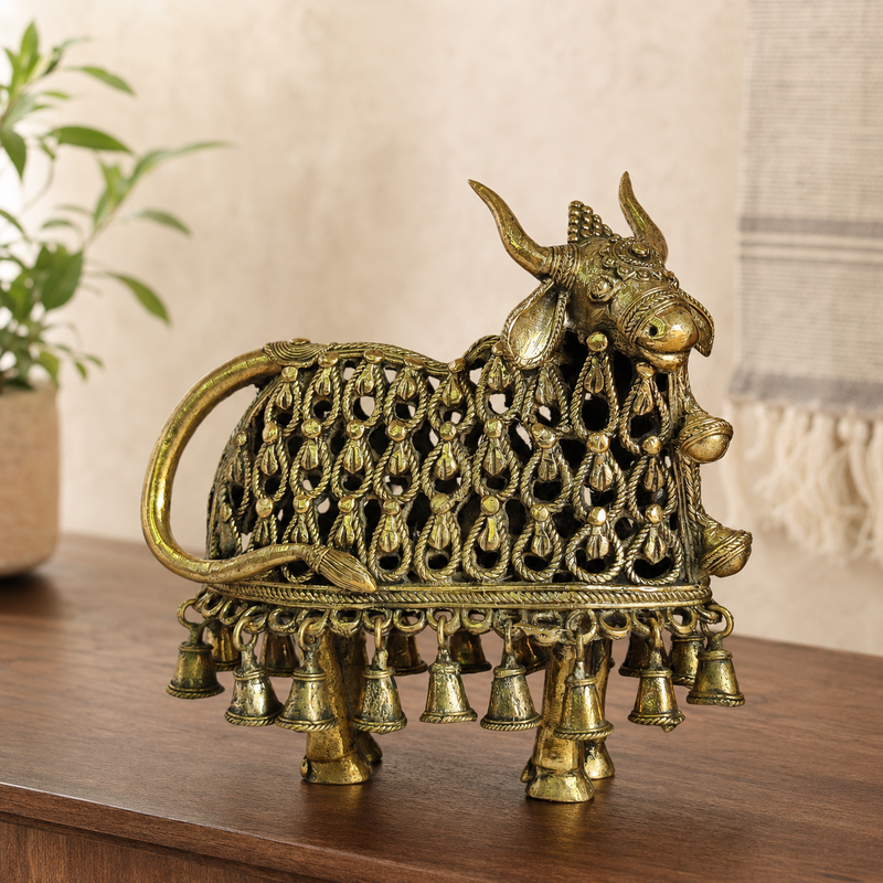 Dhokra Nandi Bell Design displayed on a walnut console in a calm living room