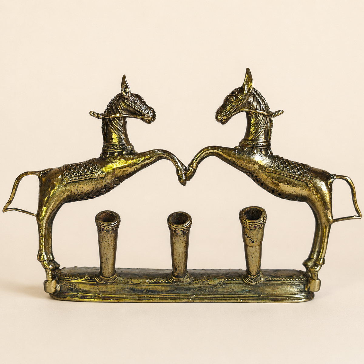Dhokra Pen Holder Design 1 with two rearing horses and three pen tubes on an ivory studio background