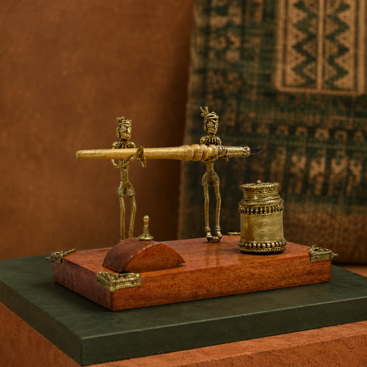 Dhokra tribal figurine pen stand in an earthy Bastar-inspired editorial setting