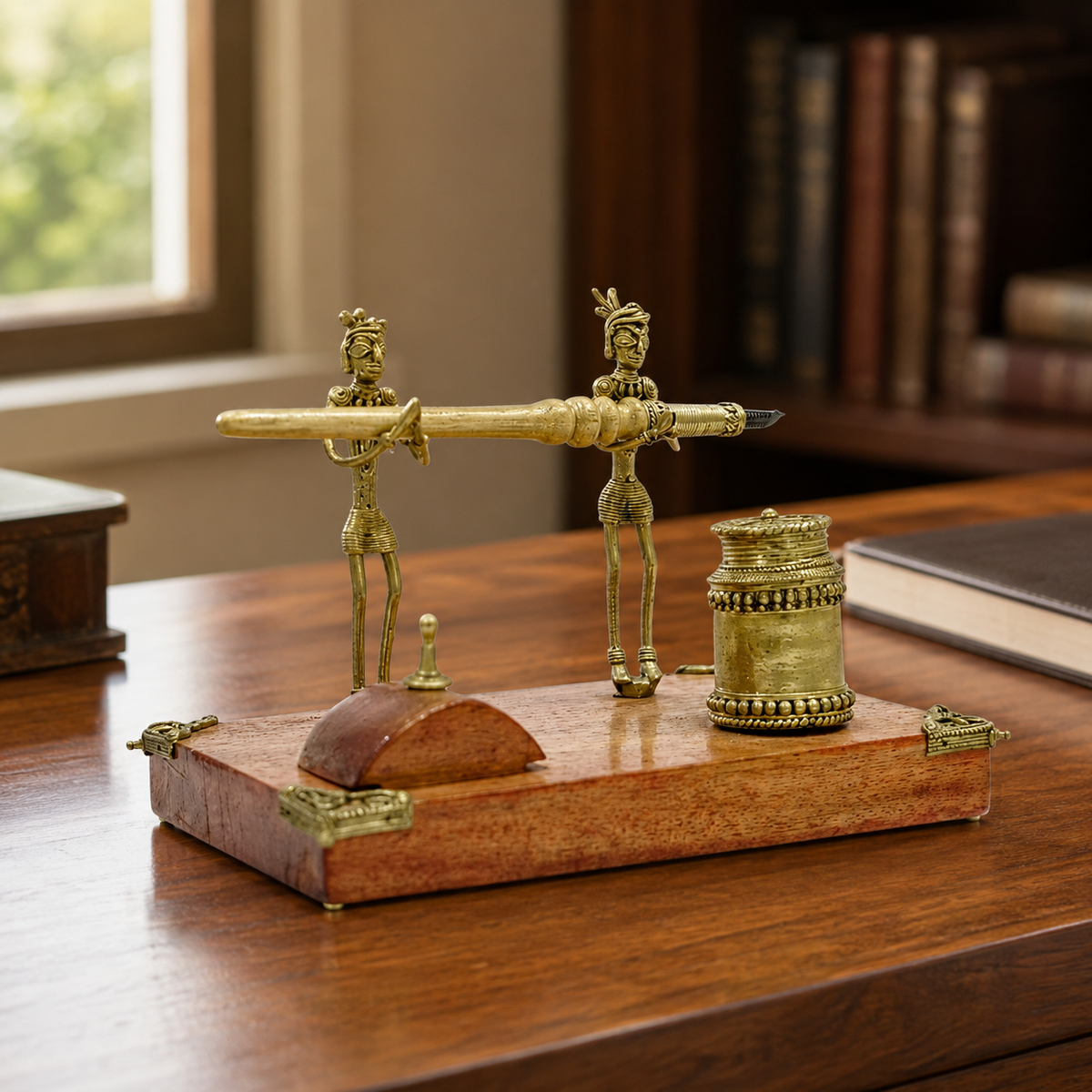 Dhokra tribal figurine pen stand displayed on a refined home-office desk