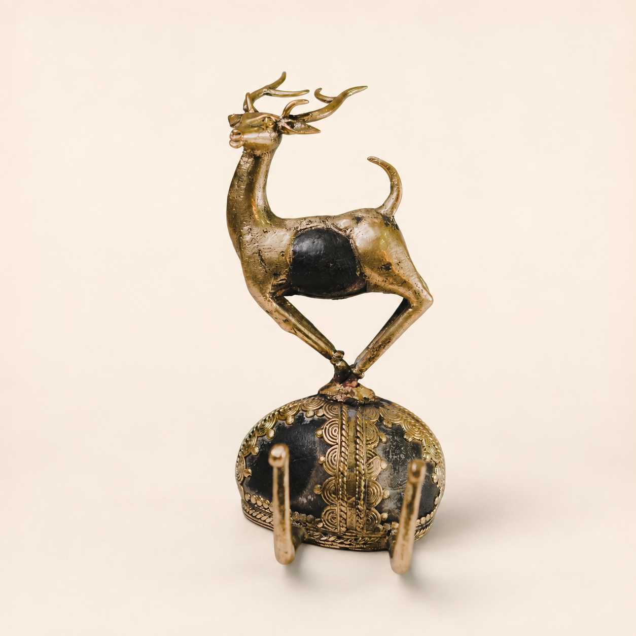 Dhokra rock fusion deer sculpture with branching antlers on a warm ivory studio background