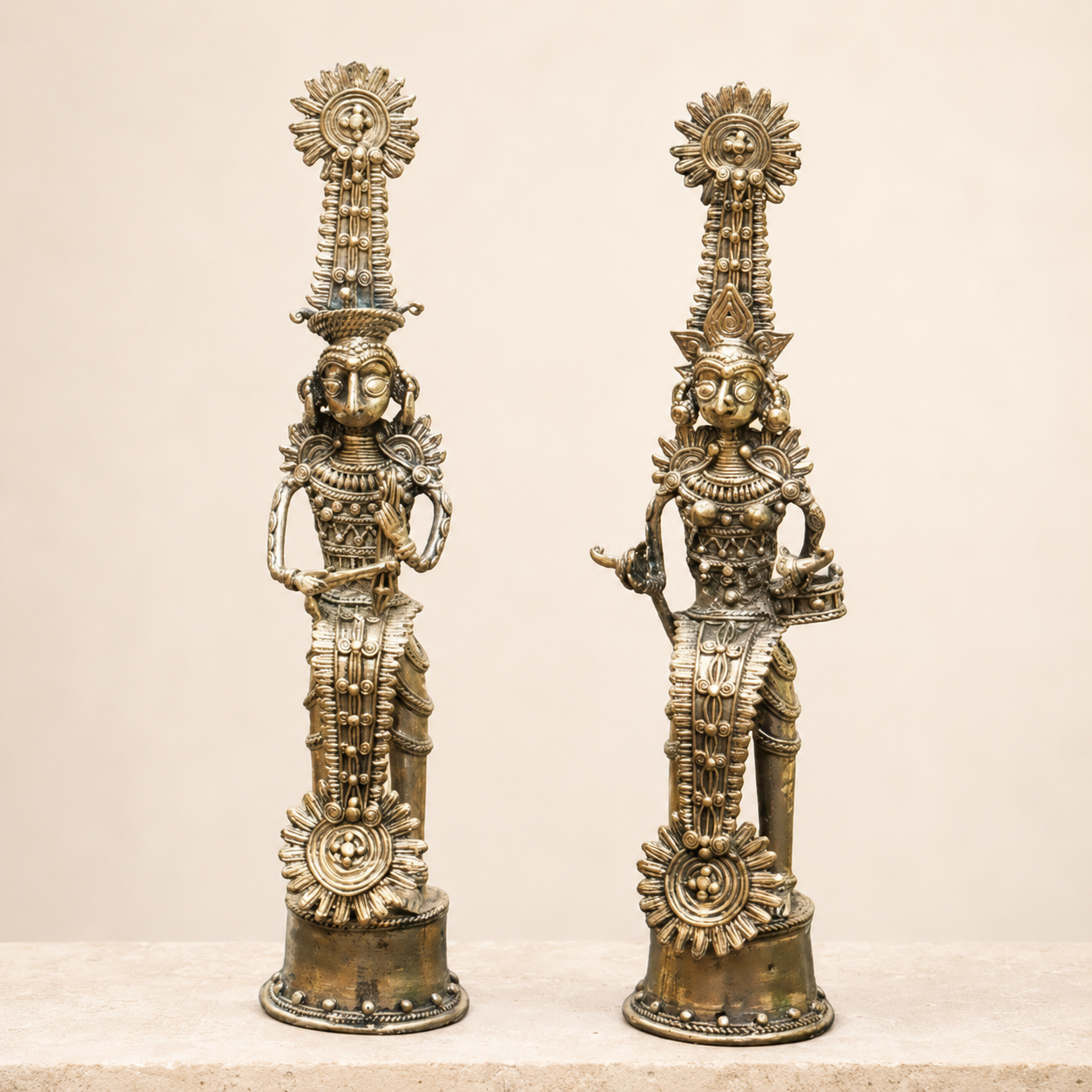 Bastar Dhokra royal ceremonial brass figurine pair on a clean ivory studio background