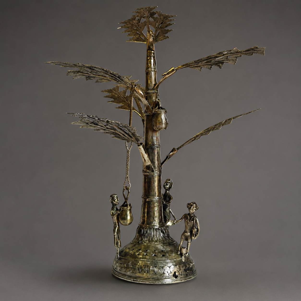 Craft detail of the figures, vessels, segmented trunk and ornamented base of a Dhokra Salfi Tree