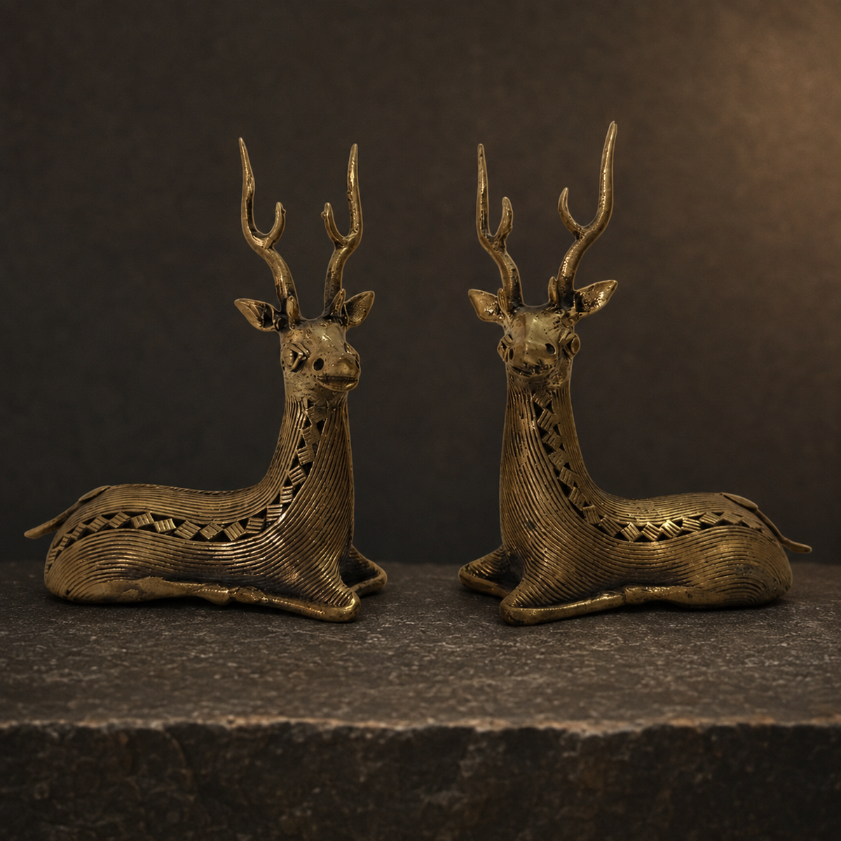 Craftsmanship detail of two Dhokra swamp deer showing lost-wax coil lines, antlers and geometric brass ornamentation