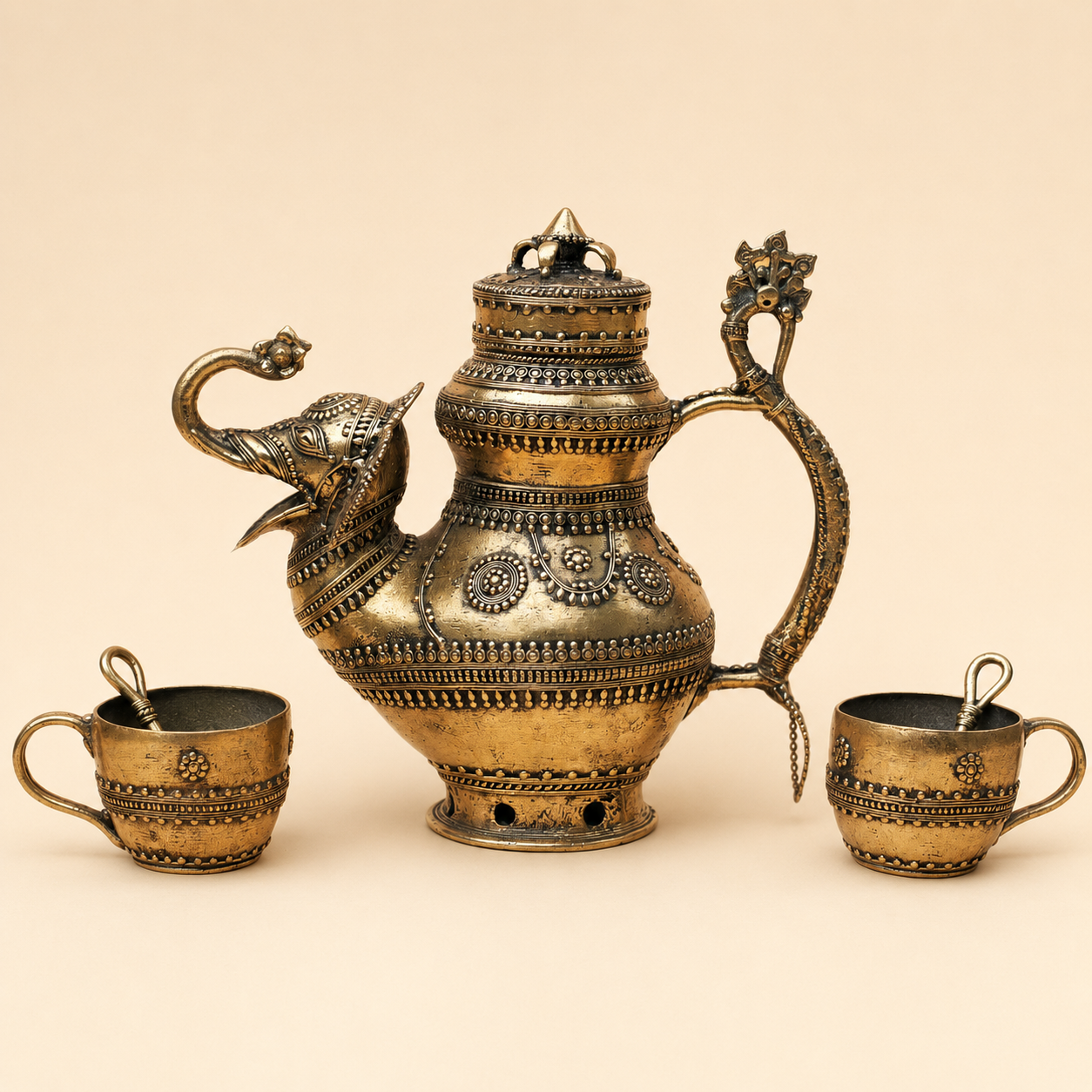 Five-piece Dhokra brass tea set on a warm ivory studio background