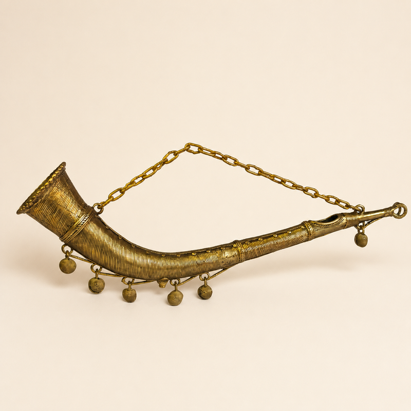 Dhokra Todi brass horn on a warm ivory studio background