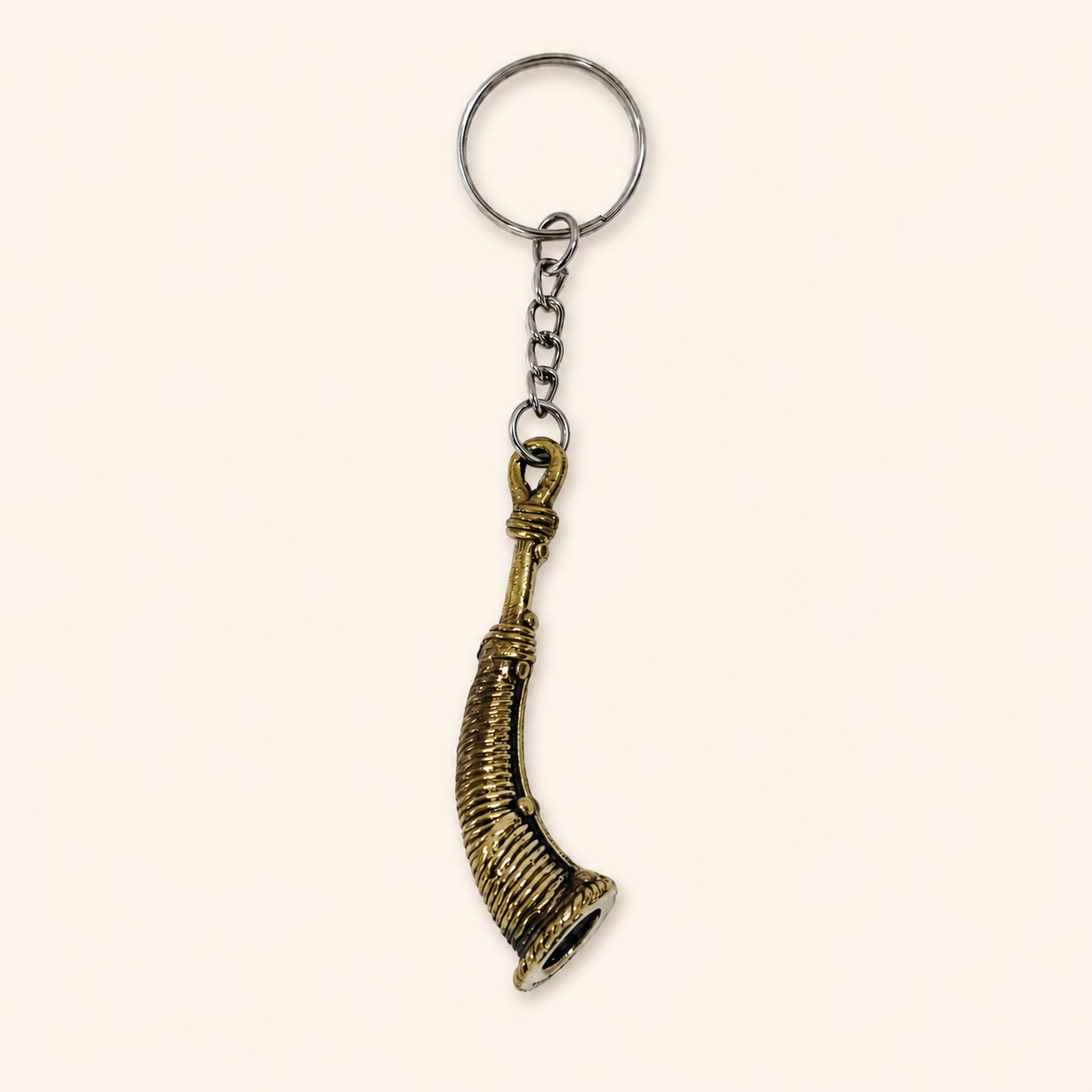 Dhokra Todi keyring on a warm ivory studio background