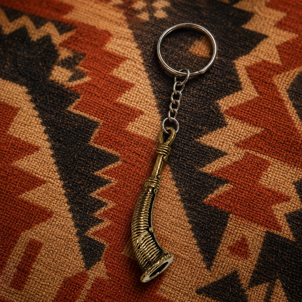 Dhokra Todi keyring on an earthy Bastar-inspired woven textile