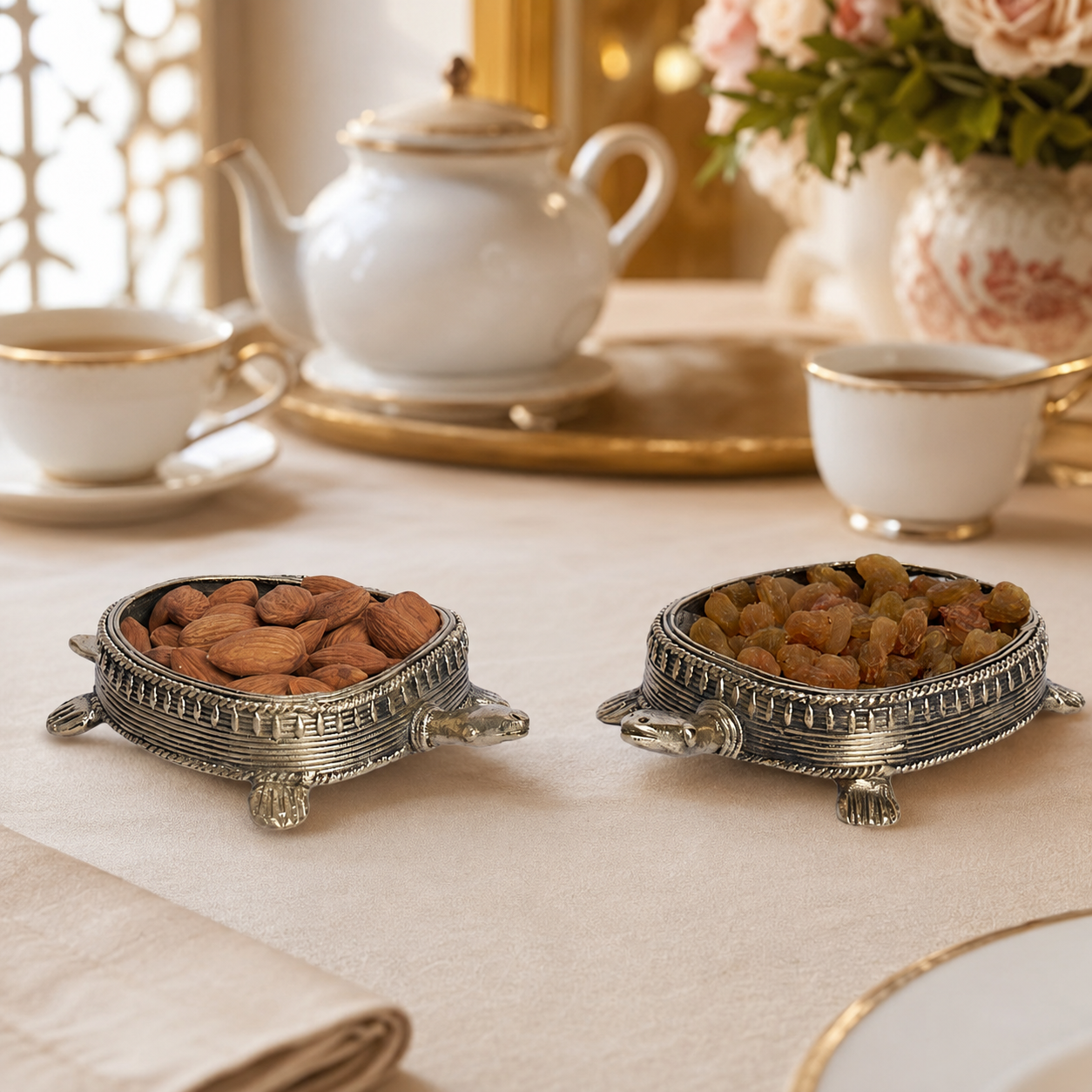 Pair of Dhokra tortoise dry fruit holders arranged for an elegant tea service