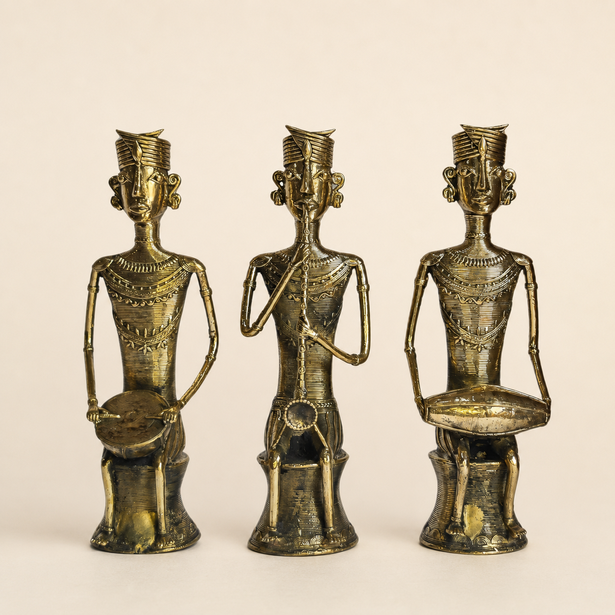 Three-piece Dhokra Tribal Musician Set on a warm ivory studio background