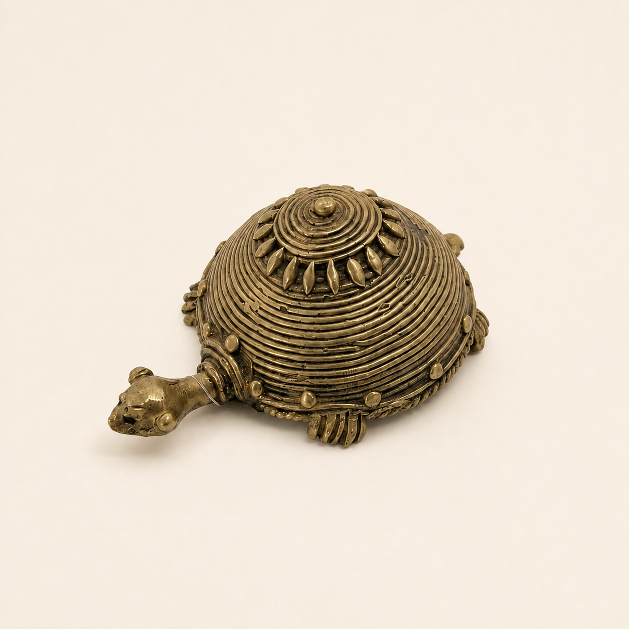 Handcrafted Bastar Dhokra brass turtle figurine on a clean ivory studio background