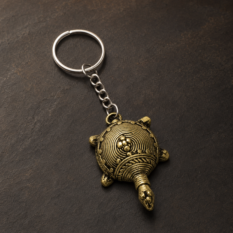 Detailed Dhokra turtle keyring showing concentric shell work, bead relief and brass patina