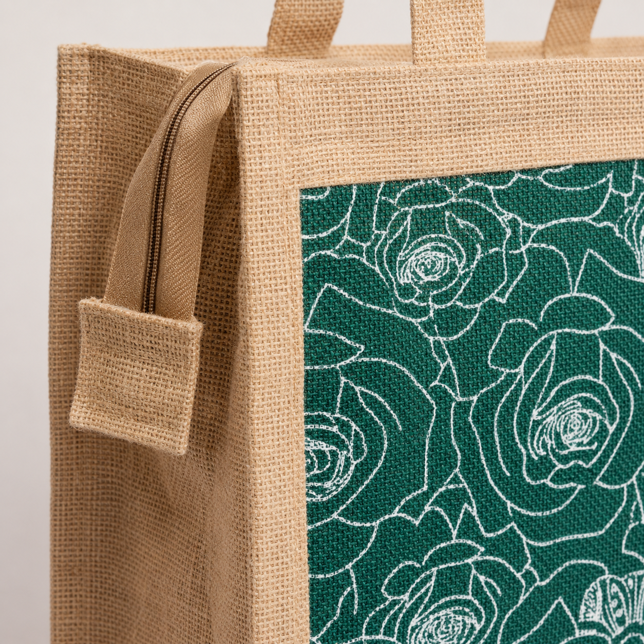Close detail of the jute weave, stitched border, floral panel, side pocket and zipper