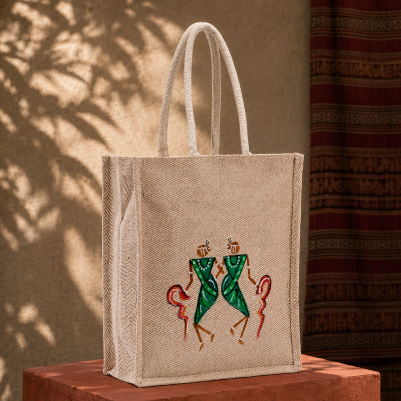 Hand-painted Bastar-style jute tote bag in a warm editorial craft setting