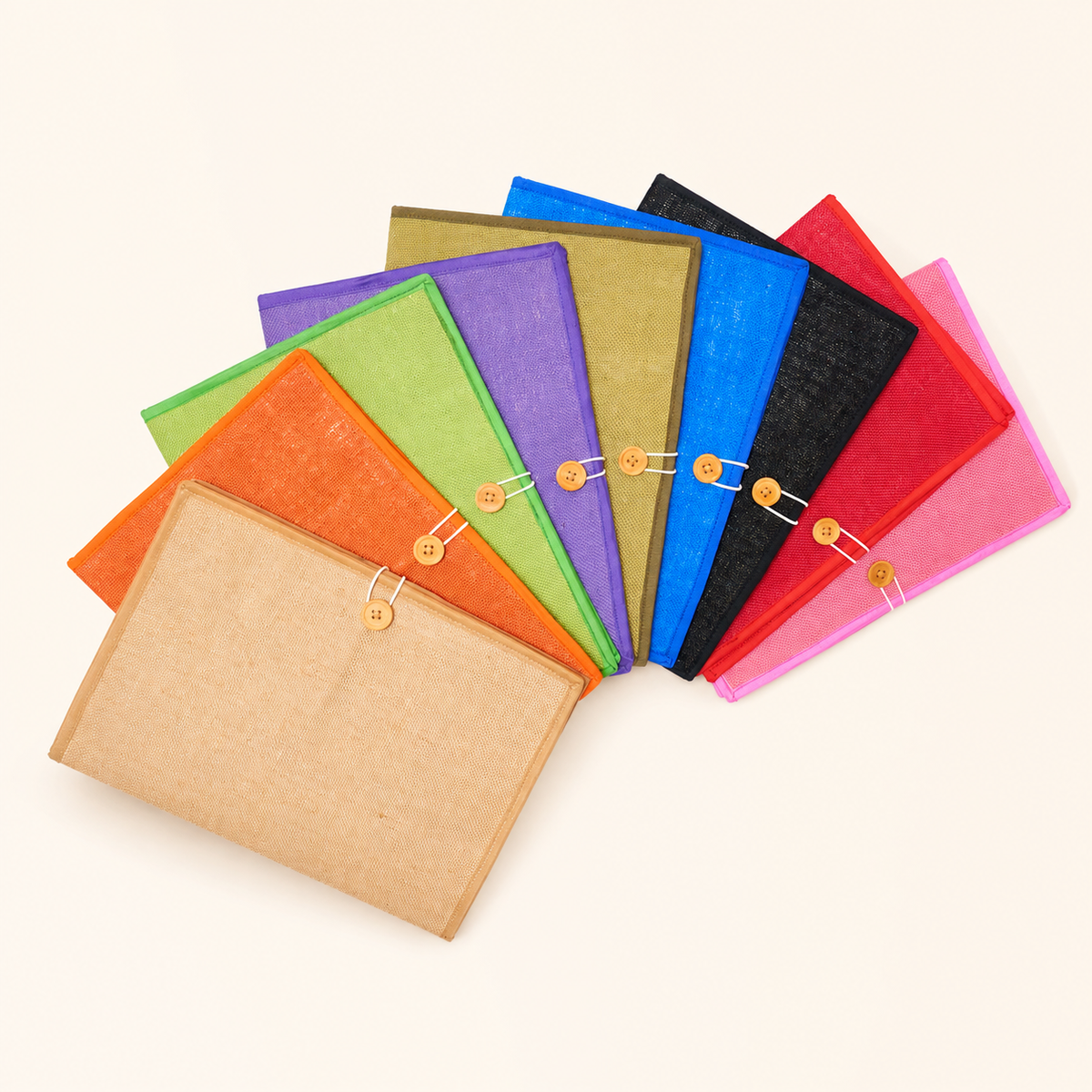 Nine multicolour handcrafted jute document folders arranged in a clean studio fan display